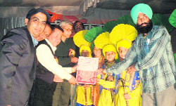 DS Garbyal, District Magistrate, Almora, gives away the prizes at a national integration camp on Friday.