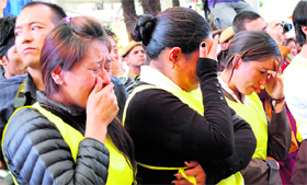 women weep during the funeral procession.