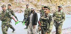 Belying the police claim, this picture obtained by The Tribune shows Huji militant Abdullan, alias Jameel, being brought back by the personnel of 10 Rashtriya Rifles after his capture near Haldroo Nullah in Doda district on Thursday.