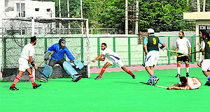 A goalkeeper tries to save a goal during a semifinal match of the Guru Teg Bahadur Hockey Championship at the KK Hakhu Stadium in Jammu on Friday