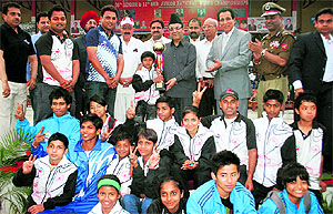 Minister for Finance Abdul Rahim Rather with the winners at the concluding ceremony of the 20th Senior and 11th Sub-Junior National Wushu Championships at the MA Stadium in Jammu on Friday