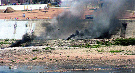 garbage being burnt on the riverbed