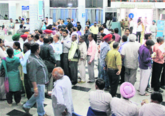 Visitors stand in queues at the State Bank of India where the server remained down for seven hours in Jalandhar on Friday. 