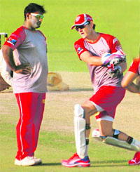Kings XI Punjabs Ramesh Powar (L) with captain-cum-coach Adam Gilchrist during a training session at the PCA Stadium, Mohali, on Friday.