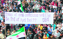 Syrian anti-regime protesters in Daraa hold a sign referring to the Friends of Syria meet to be held in Turkey on April 1.