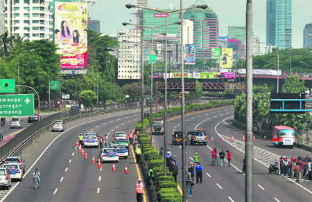 Policemen guard a toll road in Jakarta as students and workers protest against increasing fuel prices. Leading Indonesian political parties on Friday rejected a government plan to raise fuel prices unless crude oil prices climb further, dealing a blow to the ruling party's efforts to control a swelling budget deficit.