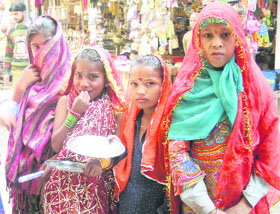 Young girls dressed as goddesses to seek alms at the Katra bus stand.