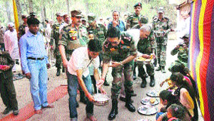 Armymen serve food to devotees at a temple close to the Line of Control in Jammu on Saturday. 
