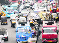 Haphazardly parked minibuses and other commercial vehicles cause traffic snarl at the Indira Chowk in Jammu on Saturday. 