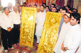 Industries Minister Anil Joshi along with members of the Durgiana Temple Management shows the gold doors which will be installed inside Ram Darbar in Amritsar on Sunday