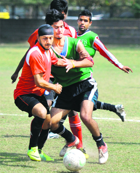 Players vie for the ball during the football match between Ambala Club and Joga Bonito at Sector 17 in Chandigarh on Sunday.