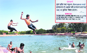 With mercury rising, children take a dip in the lake in Sector 42, Chandigarh, oblivious of the directions of the Chandigarh Administration (inset), on Sunday .