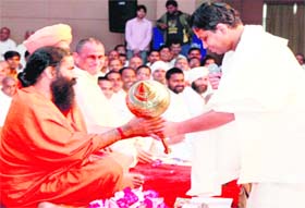 Yoga guru Ramdev being presented gadda by Acharya Balkrishan in Haridwar on Sunday