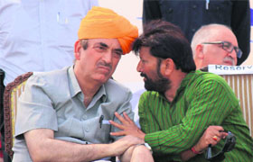 Lok Sabha member Choudhary Lal Singh has a word with Union Health Minister Ghulam Nabi Azad at a rally in Jammu on Sunday. 