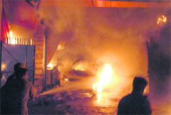Firefighters try to douse a blaze after a fire broke out in an electronics showroom near City Square Mall in Jammu on Saturday night. 