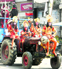 A Hanuman sena rides a tractor-trailer during a shobha yatra on Ram Navami in Jalandhar on Sunday.