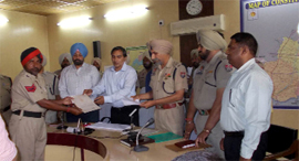 Inspector General of Police (Counter Intelligence) Rohit Chowdhry felicitates the policemen at the CPRC Centre in Ferozepur.
