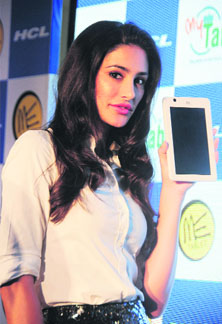 Bollywood film actress Nargis Fakhri holds a newly launched HCL tablet during a press conference in New Delhi on Monday. HCL Infosystems unveiled two products  the ME U1 and the MyEdu tablets  priced at Rs 7, 999.