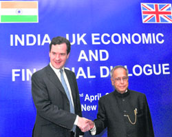 Finance Minister Pranab Mukherjee shakes hands with visiting British Chancellor of Exchequer George Osborne during a meeting of the fifth ministerial level India-UK Economic and Financial Dialogue in New Delhi on Monday.