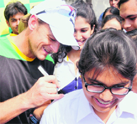 Adam Gilchrist signs on shirt of a student at DPS in Chandigarh on Monday. 