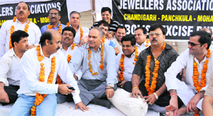 Members of the jewellers associations take part in a chain fast at Sector 22 in Chandigarh on Monday. 