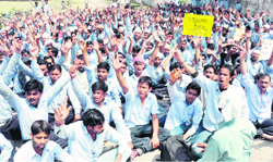 Employees of Rockman and Satyam Auto stage a protest in support of their demands in Haridwar on Monday. 