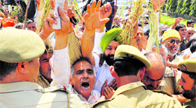Members of the Kissan Association Front being restrained by the police during a protest march in Jammu on Monday.