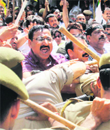 Activists of the Jammu Kashmir Democratic Front scuffle with the police during a rally in Jammu on Monday.