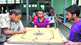 A carrom match in progress during the Inter-Department Competitions at Gymnasium Hall, University of Jammu, on Monday.