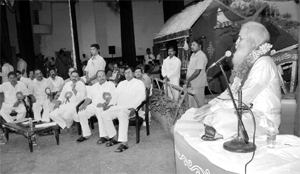 An astrologer reads out the almanac at a party meeting. 
