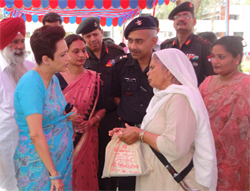 Annie Anand interacts with the widow of a martyr during the Veer Nari meet organised at the Bathinda Military Station
