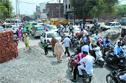 Construction material lies dumped near the junior section of the St. Xaviers School posing problem in the free flow of traffic. The problem aggravates when the school closes for the day