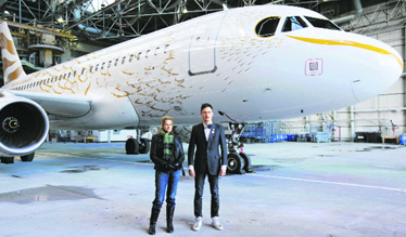British artist Tracey Emin (L) stands with designer Pascal Anson as they unveil British Airways Olympic A319 aircraft The Dove at Londons Heathrow International Airport on Tuesday. The aircraft, which was designed by Anson with mentoring from Emin, will go into service on April 4, flying thousands of passengers during the London 2012 Olympic Games that begin in July.