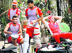 Bipul Sharma, Parveen Kumar and Shaun Marsh, members of Kings XI Punjab, rest during a practice session at the PCA Stadium in Mohali on Tuesday