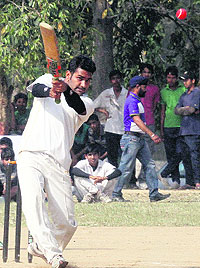 A batsman plays a shot during a match of the Gully Cricket Tournament in Chandigarh on Tuesday
