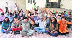 Members of the Jammu University Teachers Association stage a protest in support of their demands