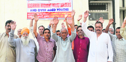 Kashmiri migrants hold a protest in the Muthi camp area of Jammu.