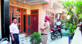An Income Tax Department team and police personnel conduct a raid on the residence of CL Kochher in Jalandhar on Tuesday.