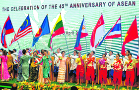 Performers carry flags of ASEAN member countries during a ceremony to mark the 45th anniversary of the association in Phnom Penh