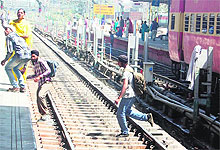 Passengers taking a shortcut through railway tracks play with danger in Amritsar