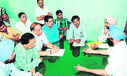 Members of the Punjab Chemists Association discuss their problems during a meeting with the district health officials in Amritsar on Wednesday
