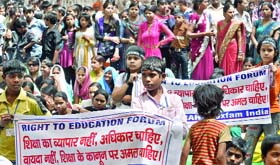 Children and their parents protest at Jantar Mantar for better implementation of the Right to Education Act in New Delhi on Wednesday