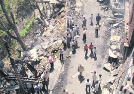 The remains of kiosks and shops gutted in a fire at Deoth Sidh in Hamirpur on Tuesday night.