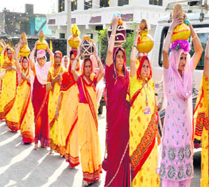 Women carry kalash on their heads during the Kalash yatra, which began in the Pouni area of Reasi district on Wednesday. 