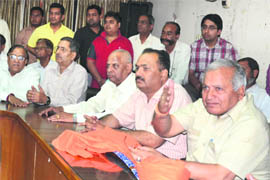 Health and family welfare minister Madan Mohan Mittal (right)  addresses a press conference at Circuit House in Ludhiana. 