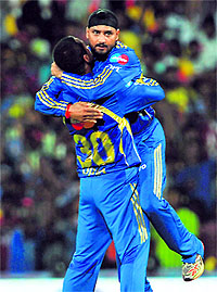 Mumbai Indians captain Harbhajan Singh (R) celebrates the wicket of Chennai Super Kings Dwayne Bravo with Pragyan Ojha in Chennai on Wednesday. Mumbai Indians won the match by wickets