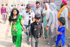 Kin of the deceased outside her house in the Gagan Avenue area of Amritsar on Thursday