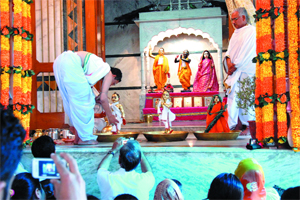 Devotees click photographs as a priest conducts the abhishek and puja on the occasion of the 12th foundation day of Shri Radha Ballabhji at Shri Chaitanya Goria Math in Bathinda on Thursday. 