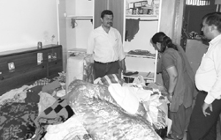 The family looks at scattered belongings at a house in the Krishna Enclave at Dhakoli in Zirakpur 