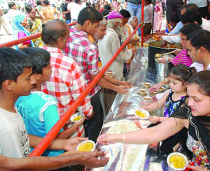 Devotees at a bhandara held at Sadar Bazar in Old Delhi on the occasion of Mahivar Jyanti on Thursday. 
